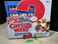 Photo of the Guess Who? board game in the original unopened box. Shows the box design with blue game frame and character cards.