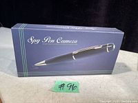 Navy blue box labeled 'Spy Pen Camera' showing image of the pen