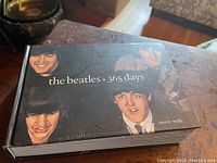 Top cover view of the vintage book showing Beatles portraits and the title 'the beatles 365 days'.