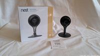 Both Nest Cam Indoor cameras displayed together; one new in box, one out of box