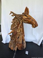 Front and side views of wooden horse head sculpture showing texture, size, and detail