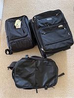 Overview of all three items: eBags laptop backpack (new with tags), Incase laptop backpack, and Travelpro rolling carry-on luggage with wheels and front pockets.