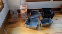 Full view of all bins including gray fabric bins, black woven basket, and stacked clear plastic bins.
