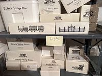 Multiple Department 56 Dickens Village Series boxes including assorted buildings and accessories