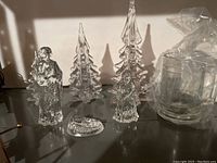 Glass nativity set with baby Jesus, Mary, Joseph, three glass Christmas trees, and five glass mugs wrapped in plastic bag.