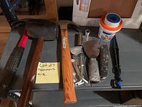 Full overview of assorted tools including hammers, mallet, hardware, tile adhesive and a pipe clamp tool
