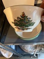 Side view of a Spode nut bowl showing detailed Christmas tree design with ornaments and figure on top.