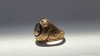 Angled view showing oval bezel and side engraving details