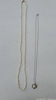 Both necklaces laid flat showing full length and clasp details.