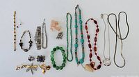 Full lot image showing assortment of jewelry including beaded necklaces, bracelets, brooches, and earrings