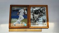 Two framed autographed photos side by side: left photo is Rob Cano in Mets uniform in color; right photo is Jerry Rice football catch in black and white.
