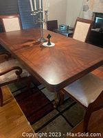 Top and corner view of wooden dining table with two chairs