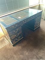 Front angle view showing desk’s twin pedestal design and top surface