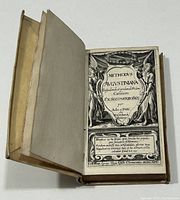 Open book showing vellum boards and engraved title page