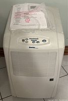 Front and top view of the Danby Designer air dehumidifier showing control panel with buttons and digital screen, unit's white plastic body and air intake vents.