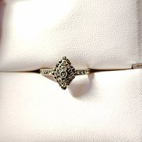 Front view of silver marcasite ring showing raised diamond-shaped cluster of marcasite stones on silver band.