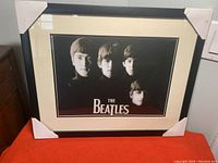 Front view of framed Beatles print showing the black and white portrait and The Beatles text.