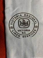 Close-up of the printed seal reading 'Victoria Regional Linen Services, Victoria B.C.' with crown emblem.