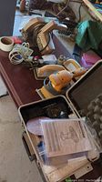 Photo of the Black and Decker circular saw on a table along with the sander and an open metal case containing the Mastercraft drill and sanding discs.
