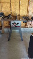 Full front view of the Sears Craftsman 10" motorized table saw on stand in garage setting.