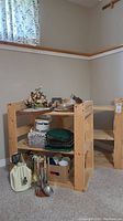 Photo showing one wood shelf filled with various household items including kitchen utensils and decor.