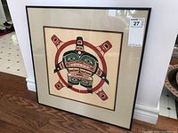 Framed Indigenous print titled 'Killer Whale in Sun' with native design of killer whale and sun in red, black and green colors