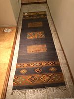 Full length view of the runner rug showing color and pattern design.