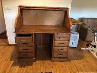 Front view with tambour top in open position, showing writing surface and drawer configuration