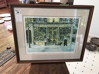 Framed print with a winter street scene titled 'The Owl and The Pussycat' in front of a toy shop.