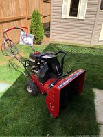 Oblique full view of snow blower on grass