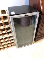 Front view of Danby wine cooler showing glass door and black top surface