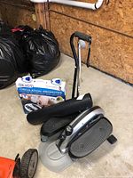 Photo shows Stamina stepper exercise equipment with black exercise mat partially rolled up and boxed Dr. Ho Circulation Promoter in background.