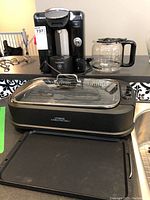 Lot showing Power Smokeless Grill, Bosch coffee maker, and Oster coffee carafe on table