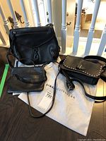 Overview photo of three Aimee Kestenberg black leather purses showing style and scale