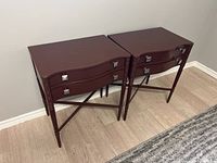 Pair of brown wooden night stands with two drawers each, showing front and side views.