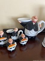 Front angle showing the large gravy boat, salt and pepper shakers shaped as waiters with bread loaves, biscuit holder, sugar and creamer pitcher all featuring Italian waiter design.