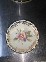 Top-down view of the Imperia Limoges ring dish showing hand-painted floral design with gold accents and scalloped edges