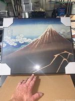 Front view of the 16x20 canvas print showing Mount Fuji with clouds and rainstorm in stylized art.