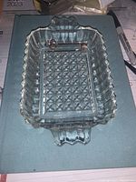 Top view of the vintage clear pressed glass rectangular dish showing the geometric cut pattern on the base and the handles.