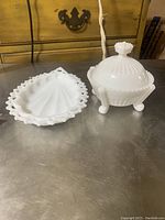 Photo showing two items: oval trinket dish with lace edge and round covered dish with lid and legs
