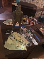 Wide view of Chewbacca figure standing beside Snowspeeder and bagged figures on dresser