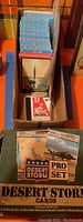 Photo of trading card stack in box including Desert Storm cards visible at front