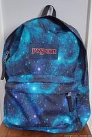 Front view of JanSport galaxy print backpack