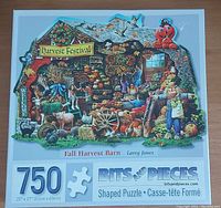 Front of Fall Harvest Barn shaped puzzle box showing 750 pieces, image of autumn harvest festival with animals and people