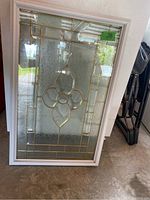 Front view of the rectangular decorative glass door insert with white frame and stained glass design.