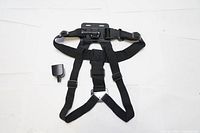 Black adjustable chest strap harness with flat mount platform and clip, laid out flat on white background.