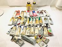 Overview photo showing 28 tubes of assorted oil paint in multiple colors along with the two bottles of linseed oil.