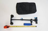 Photo showing the stabilizer collapsed beside measuring tape and black carry bag