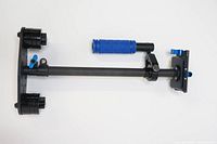 Top view of the carbon fiber camera stabilizer showing mounting plate, counterweights, and blue handle grip.
