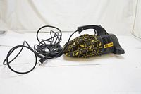 Full view of the Dirt Devil Royal Series 500 handheld vacuum with attached long black power cord